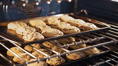 Zwei Bleche mit Keksen im Ofen