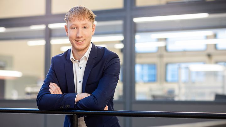 Recruiter Maximilian Zuncke steht an einem Geländer 