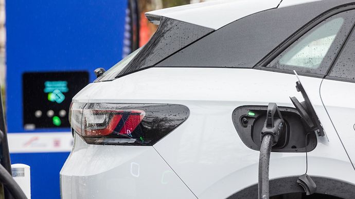 Ein weißes Elektroauto wird an einer Ladestation von Mainova aufgeladen.