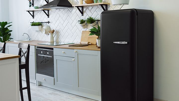 Küchenzeile mit großem schwarzem Kühlschrank rechts